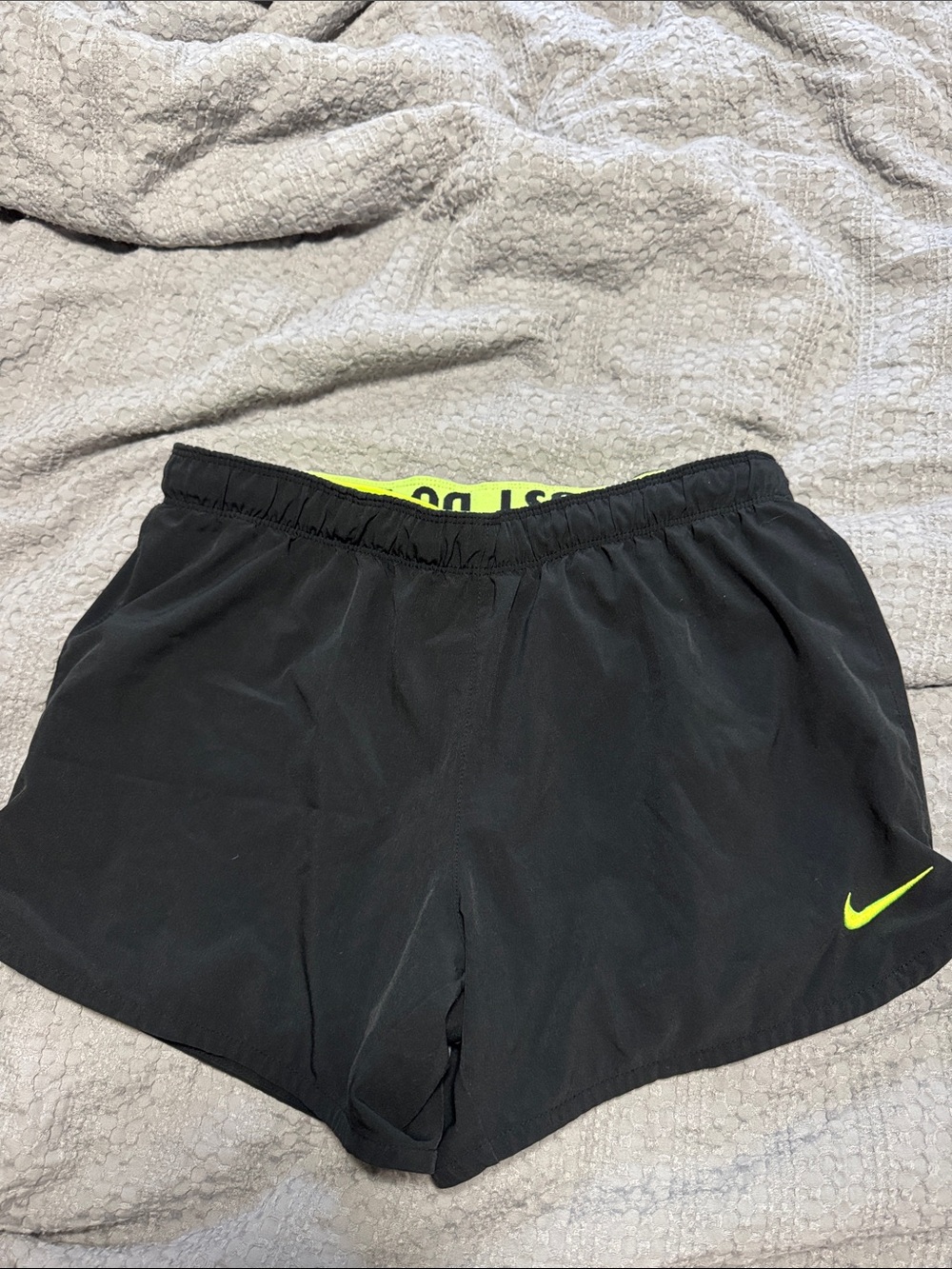 Nike Women's Black Athletic Shorts with Neon Yellow Swoosh